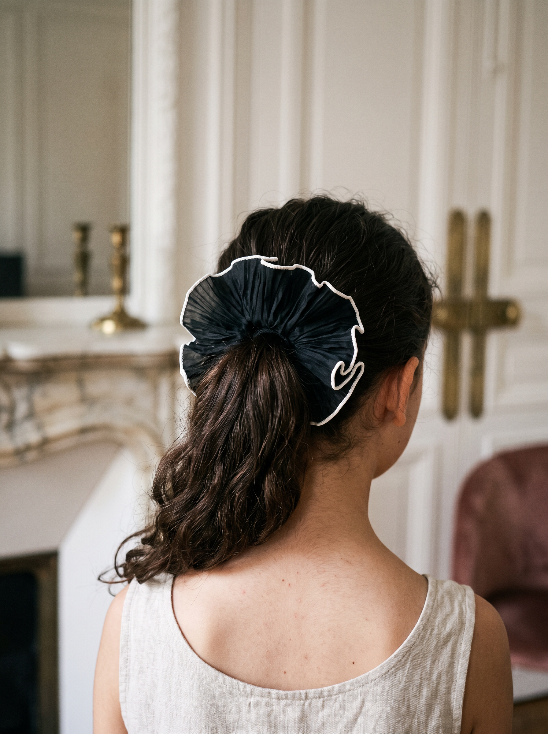 Black Tulle Ruffle Scrunchie — worn in a child's hair