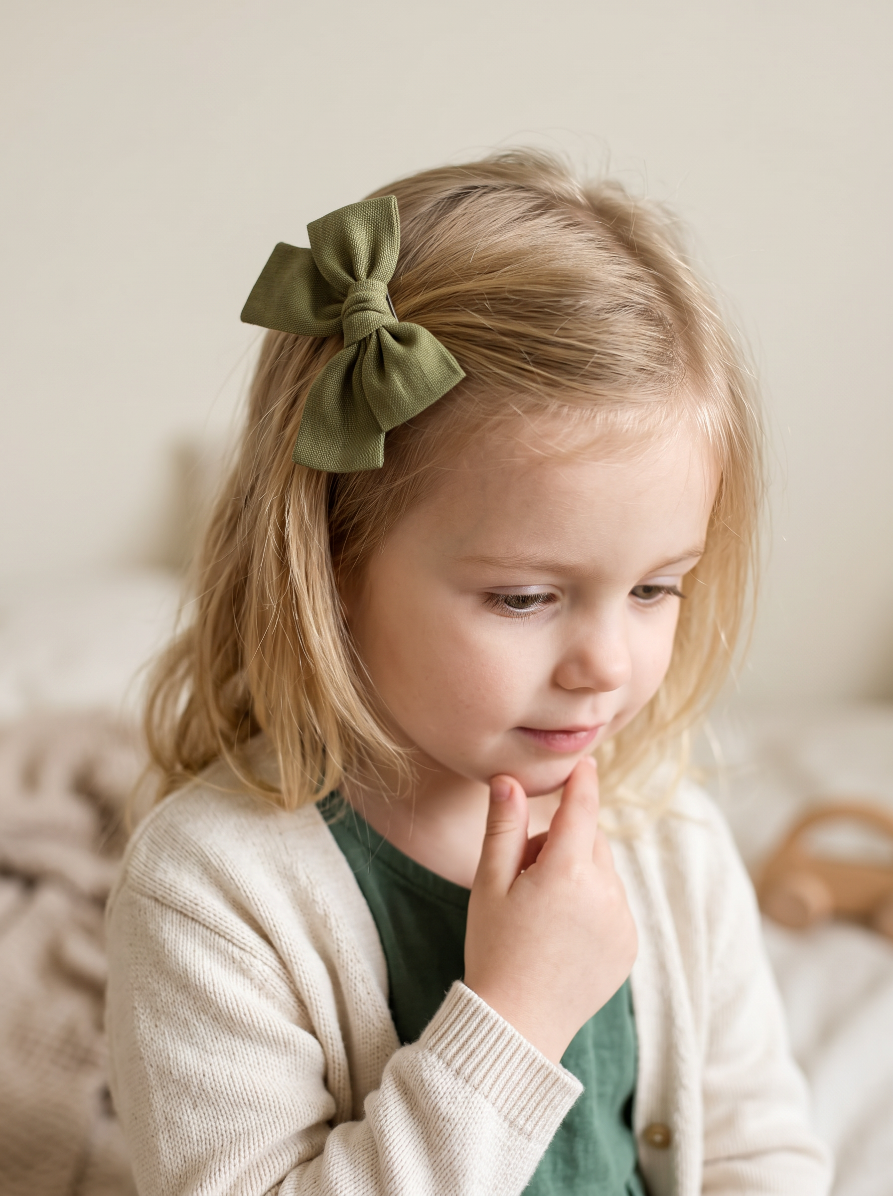 Olive Linen Bow — worn in a child's hair